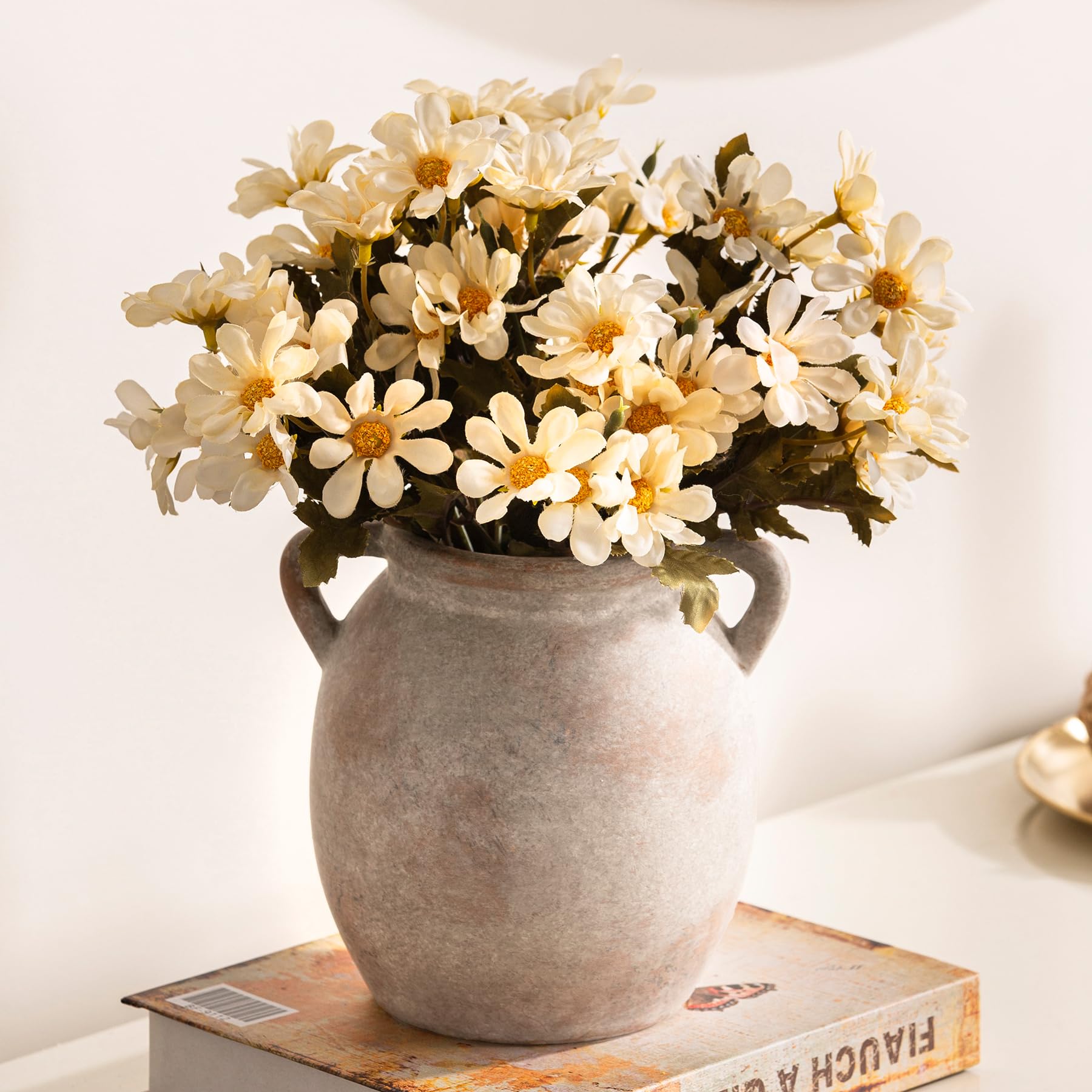 Dobbyby vase with dried flowers creates a warm mantel focal.
