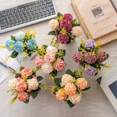 Donmills dining table centerpiece showcases hydrangea in a ceramic pot.
