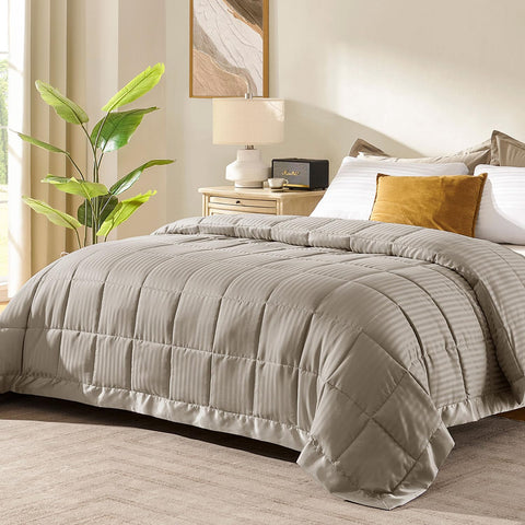 Downluxe king-size blanket in sand color folded for storage, soft texture