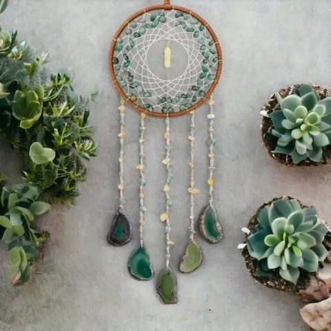 Dreamocean boho dream catcher with green turquoise crystals sparkling in a window