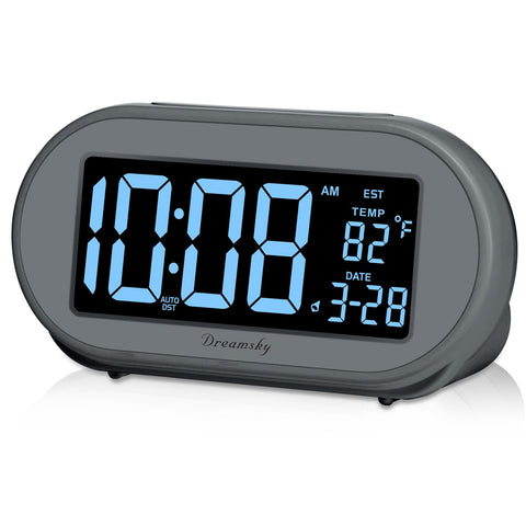 DreamSky alarm clock on a nightstand with a clear bedside LCD display for quick time checks.