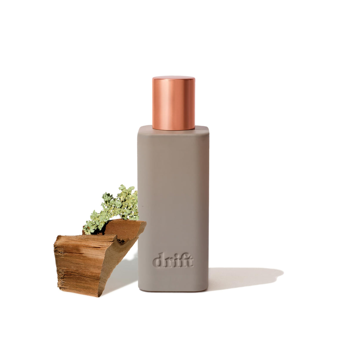 Drift Teak room spray bottle releasing a warm, inviting scent for any space.
