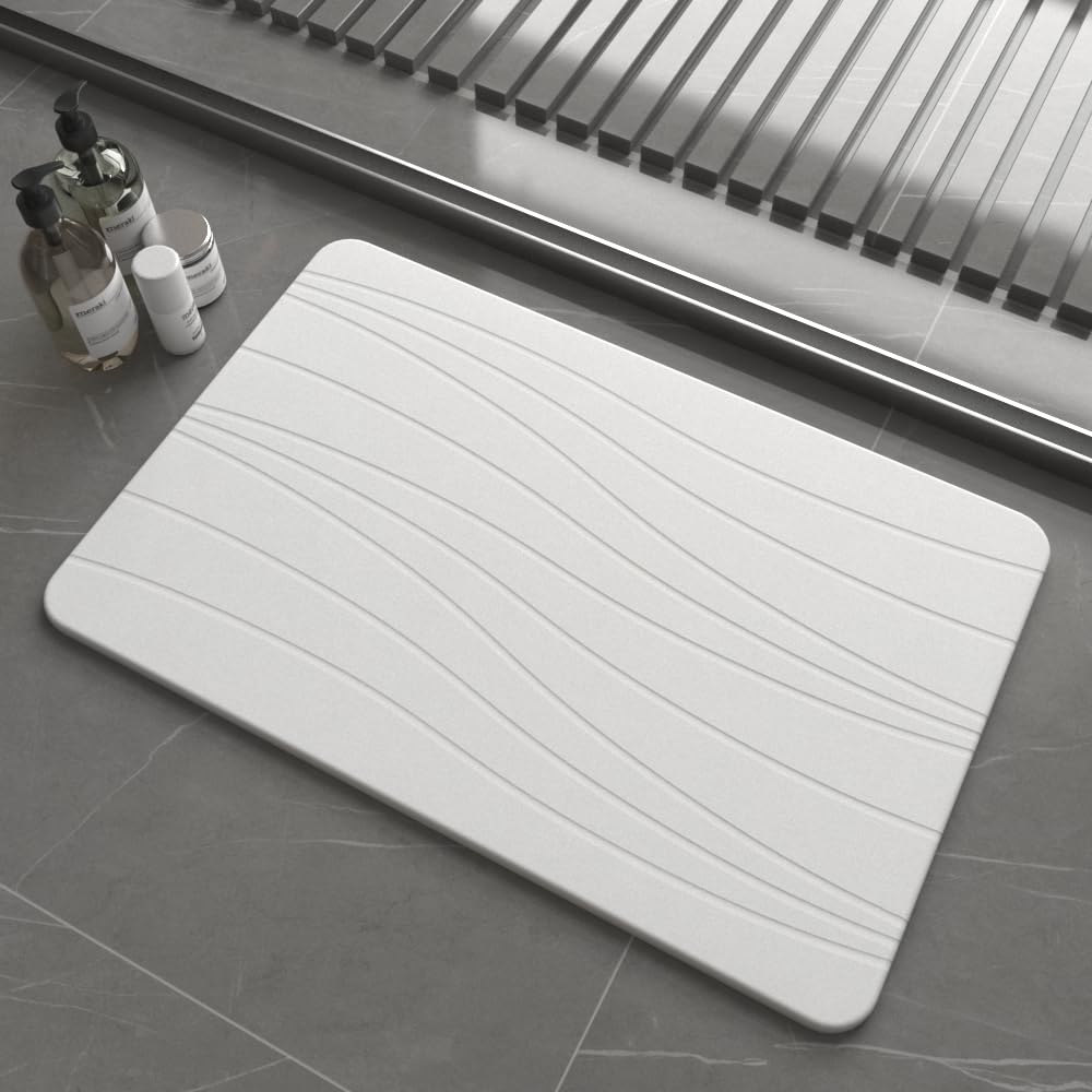 Drvykkn fast drying stone bath mat showing absorbency in a modern bathroom