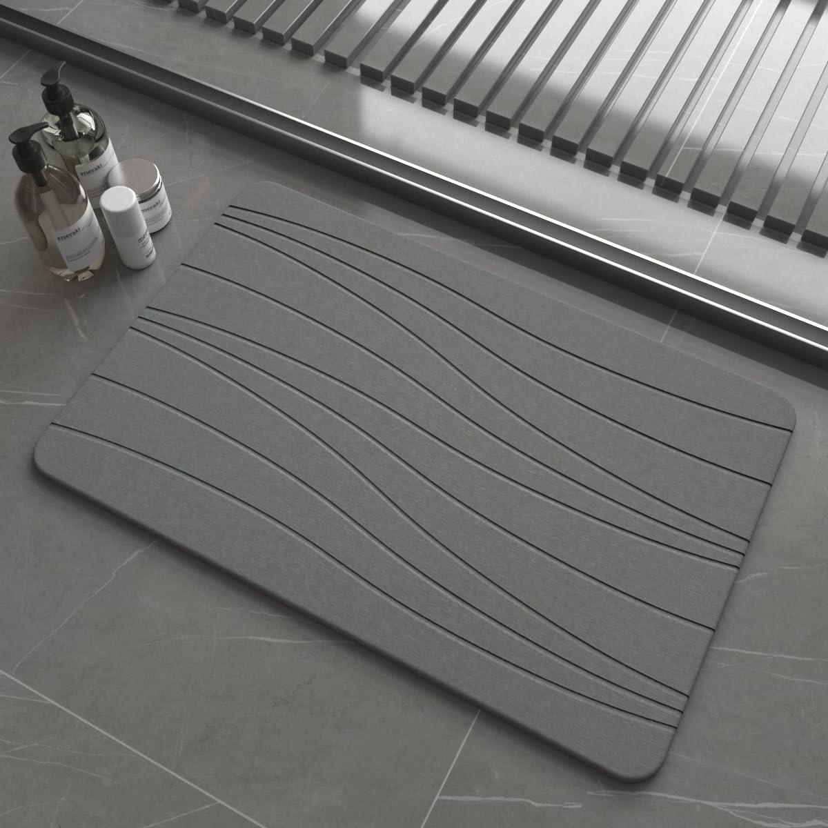 Drvykkn fast drying stone bath mat in dark gray wave shows rapid moisture evaporation