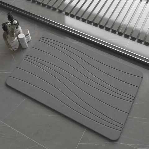 Drvykkn fast drying stone bath mat in dark gray wave shows rapid moisture evaporation