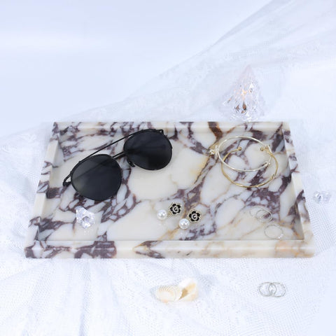 DUANYAN marble tray displaying perfume bottles neatly.