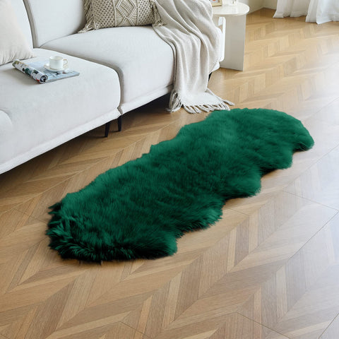 Duduta emerald green rug beside a sofa creating a warm decor accent
