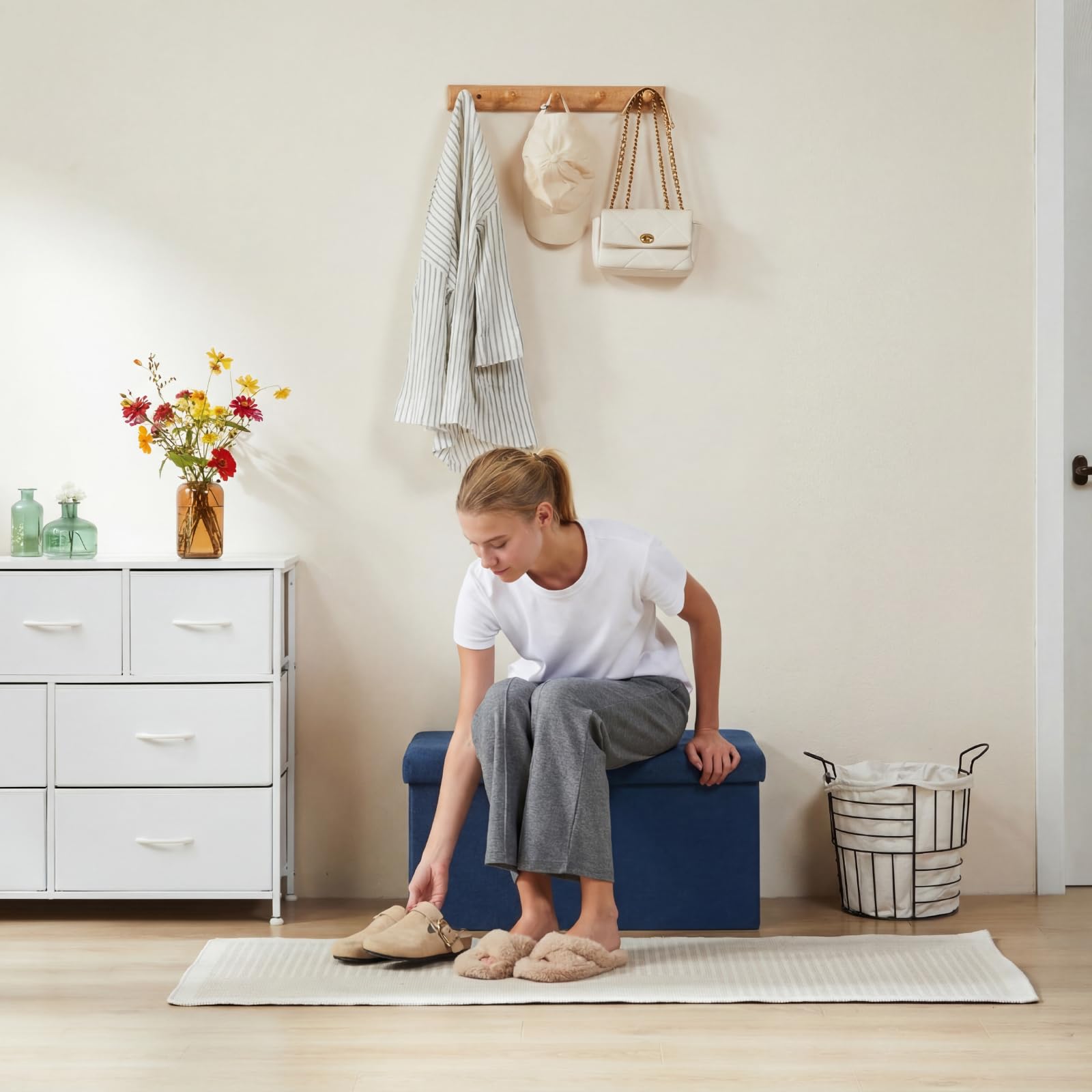 DUMOS blue ottoman with lid open showing spacious 35-gallon storage space.
