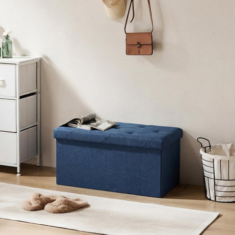 DUMOS blue ottoman in a modern living room setup.