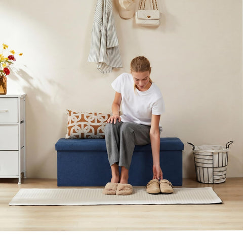DUMOS foldable storage ottoman blue side view highlighting slim profile.