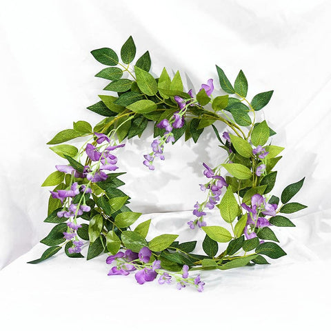 DVGUN romantic garland arch with rich purple wisteria blooms.
