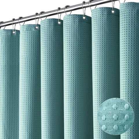 Dynamene teal waffle fabric curtain adds texture and privacy to a modern bathroom