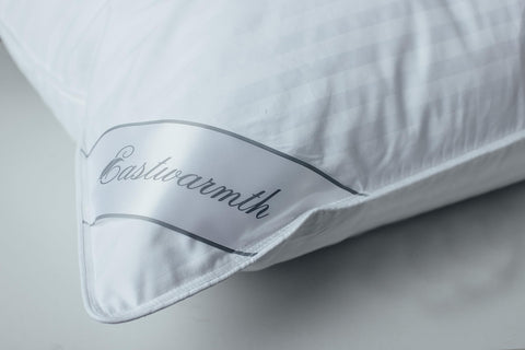Eastwarmth pillow on a bed creates a calm, restful sleeping setup