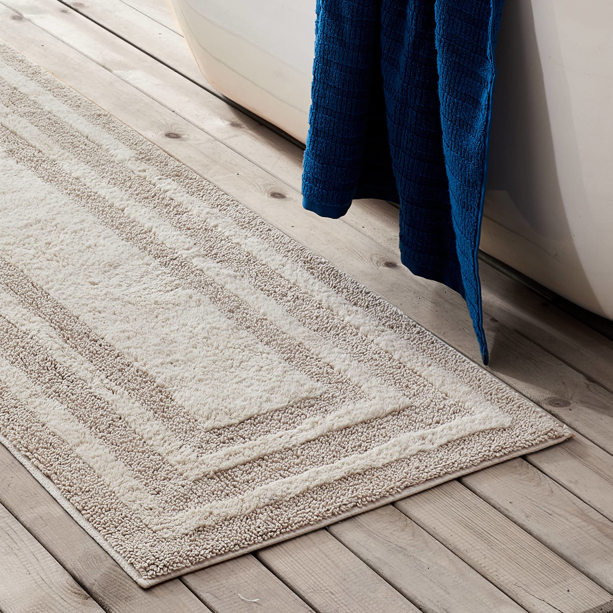 Eddie Bauer Logan Beige rug featuring non-slip backing on bathroom floor
