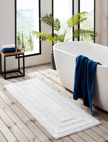 This rug's absorbent cotton dries quickly to keep floors drier after showers.