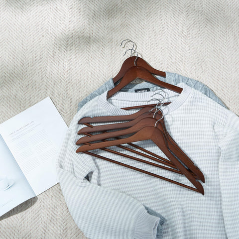 Smooth finish on ELONG HOME wooden hangers protects fabrics from snagging.