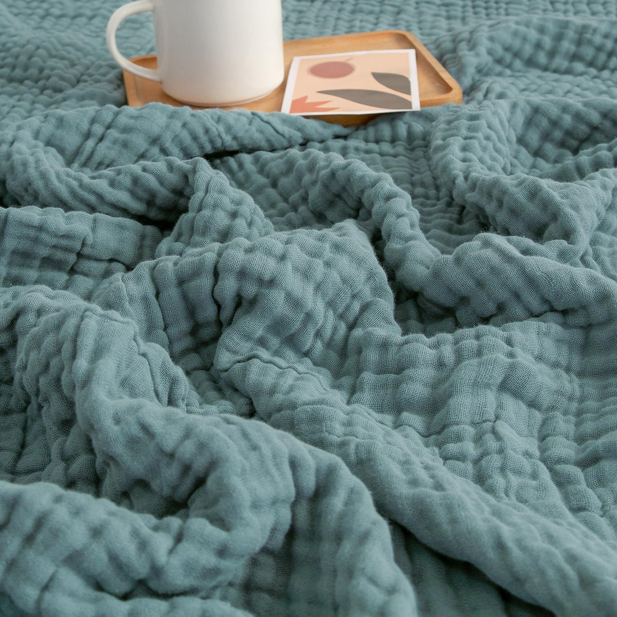 EMME muslin blanket teal laid flat showing 60x80 size for all-season comfort.