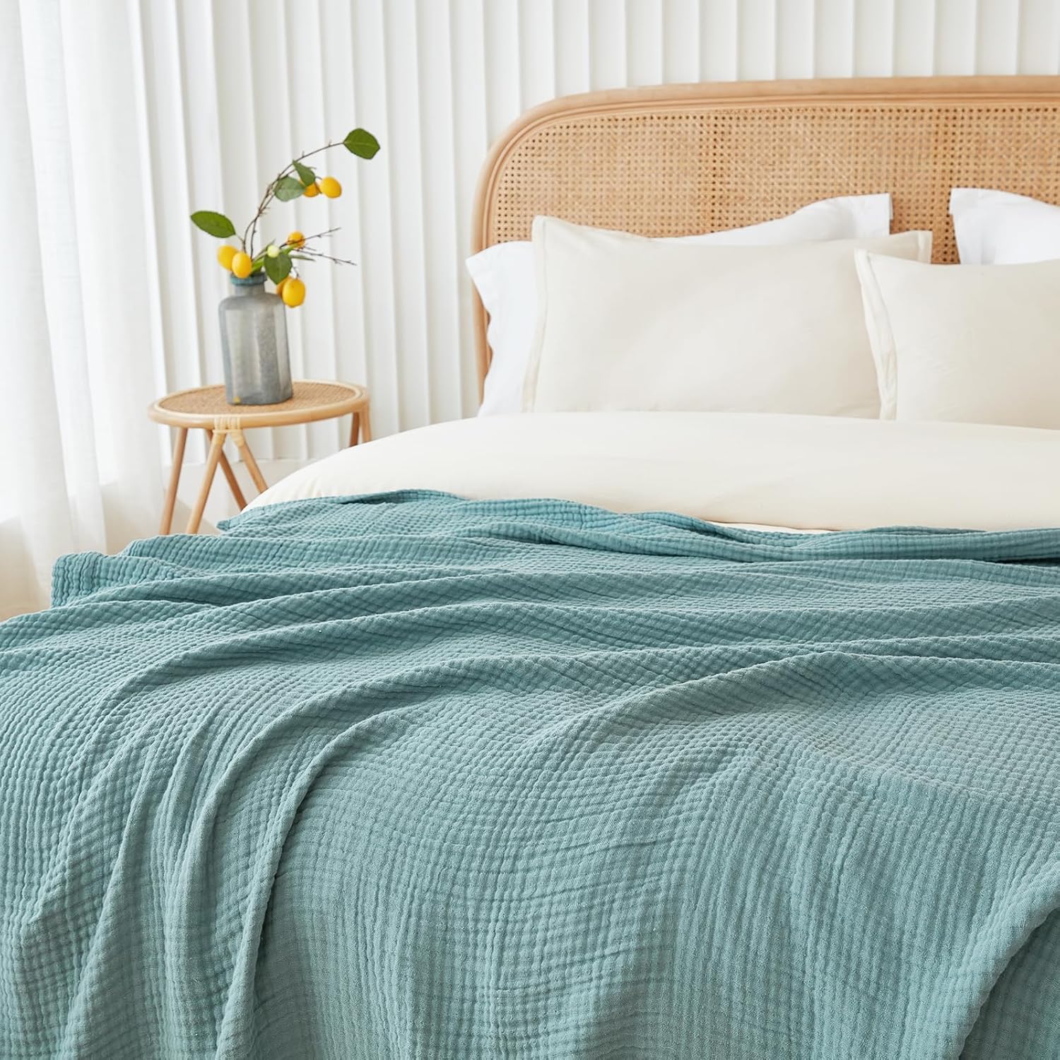 Gift-ready packaging with EMME teal muslin blanket for occasions.