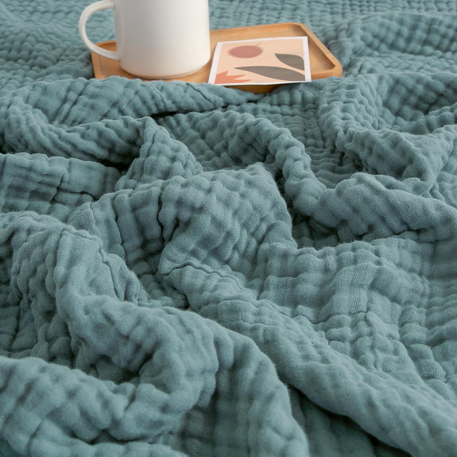 EMME muslin throw blanket in teal 50x70 offers couch warmth and breathable comfort.