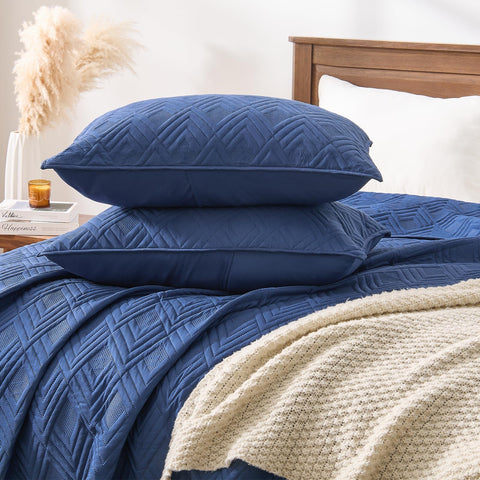 EMME Quilts pillow shams included in navy complement the look.