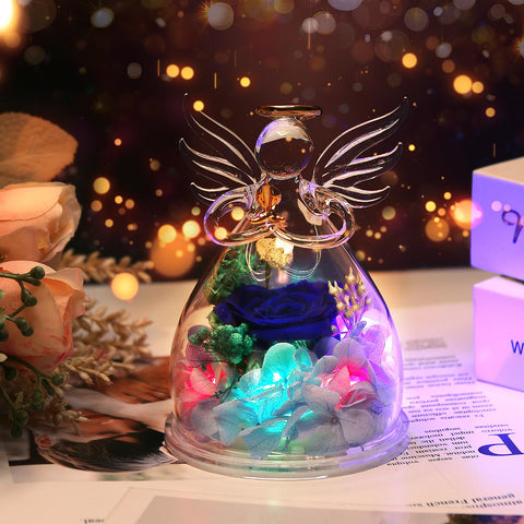 Encavy blue rose in glass angel, delicate decor for anniversaries.