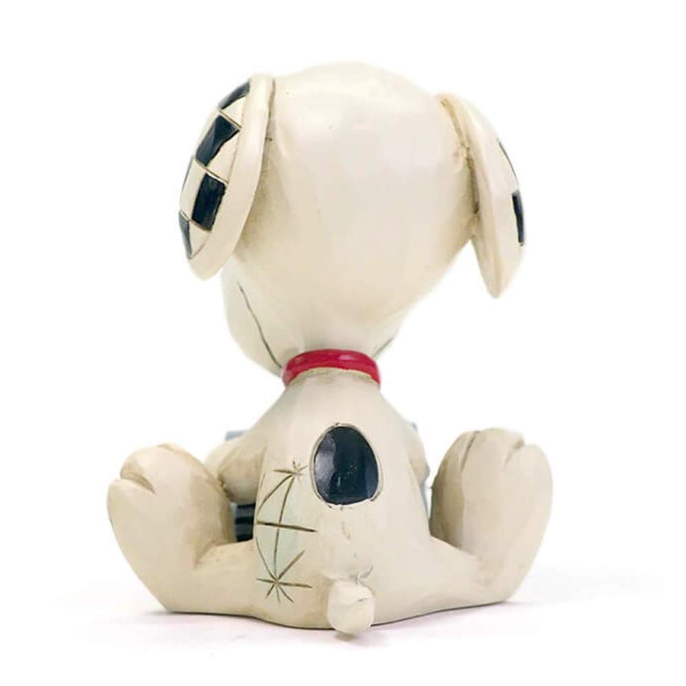Snoopy scene evokes cozy storytelling moments on a shelf.