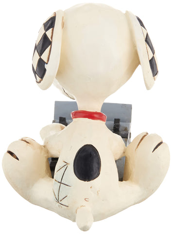 Enesco Snoopy typing on a typewriter captures a playful literary vibe for desk decor.