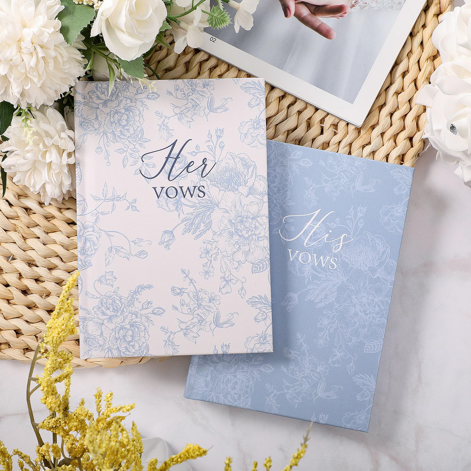 Engrowtic vow books in hand beside wedding decor for keepsake.