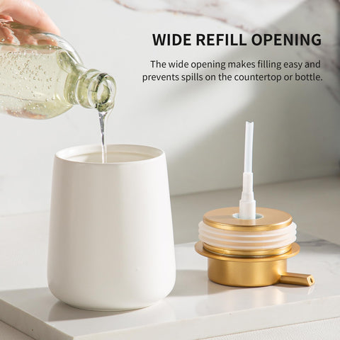 Enra ceramic dispenser with gold pump close-up in white finish.