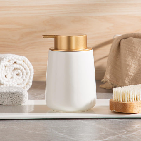 Gift-ready Enra ceramic dispenser in white with gold pump packaging.