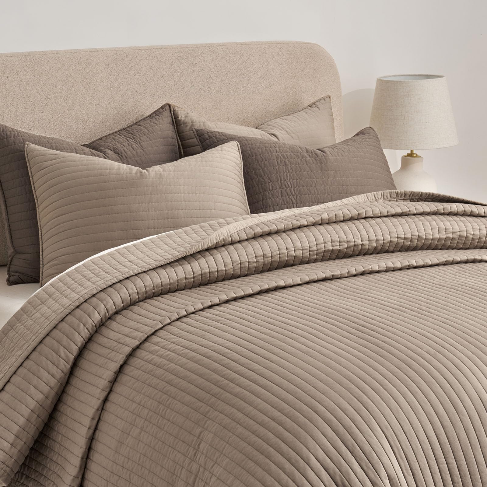 Evergracehome stone taupe quilt set styled in a modern bedroom setting.