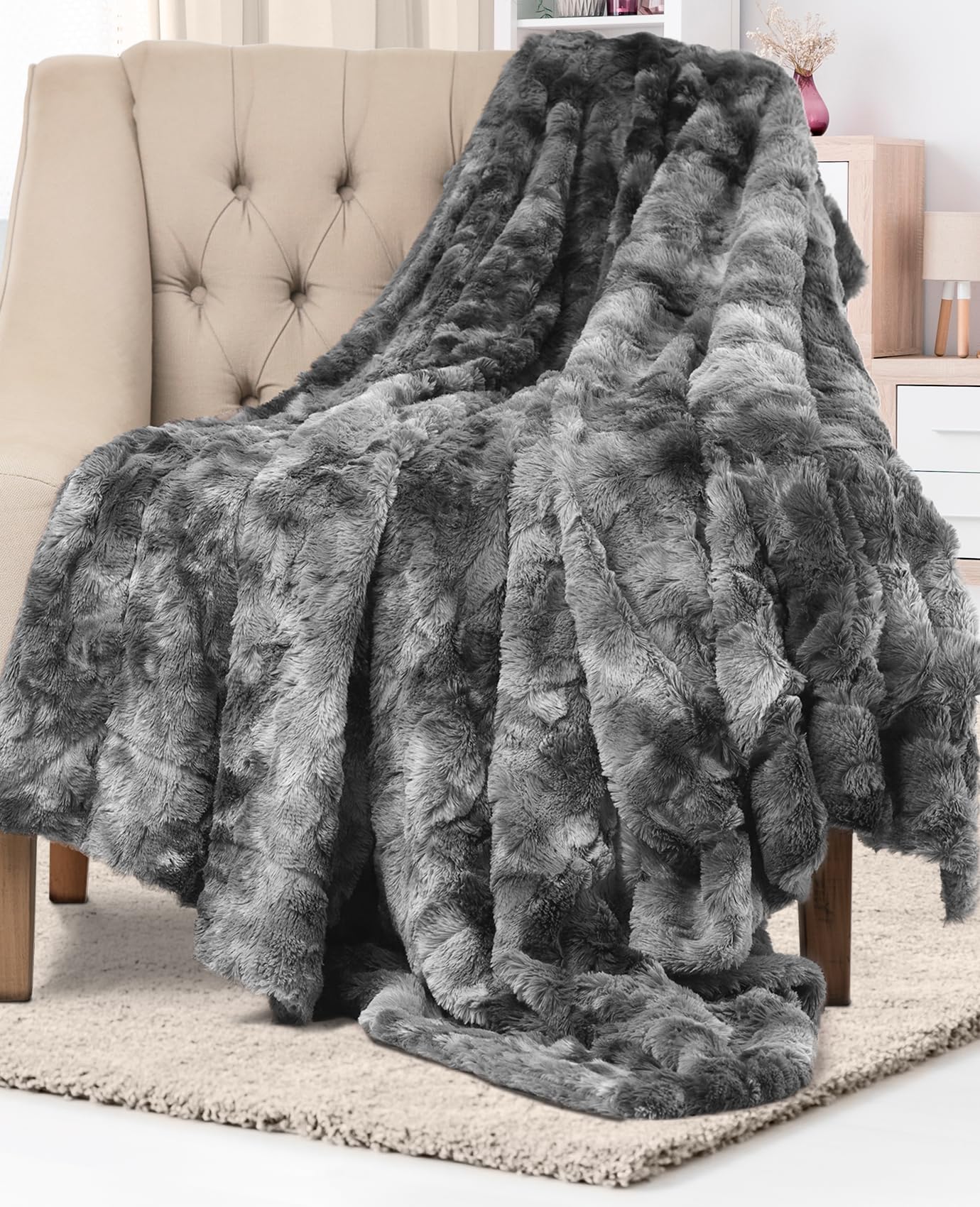Everlasting Comfort gray faux fur throw blanket on a couch, soft and inviting.