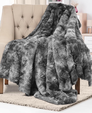 Everlasting Comfort gray faux fur throw blanket on a couch, soft and inviting.