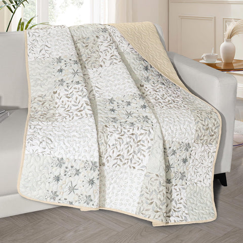 Exclusivo Mezcla 50x60 quilted throw with boho patchwork on bed for cozy decor.