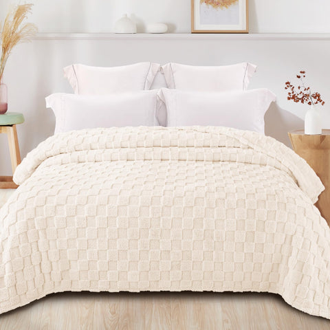 Exclusivo Mezcla ivory blanket on bed adds warmth and decorative checkered style.