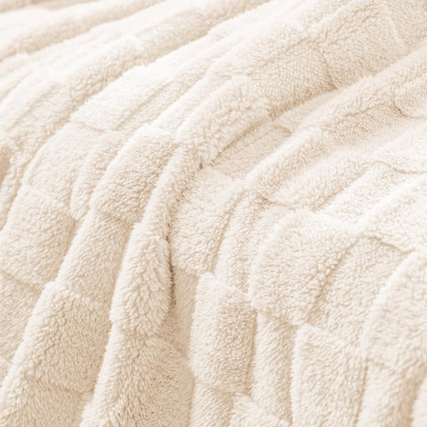 Wide shot of Exclusivo Mezcla ivory blanket in a cozy living room.