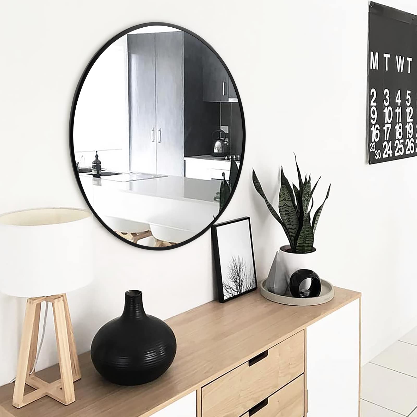 Fabuday round living room mirror reflects light to open up spaces.