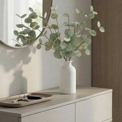 Living room accent featuring Fawairyc eucalyptus stems in a ceramic vase.