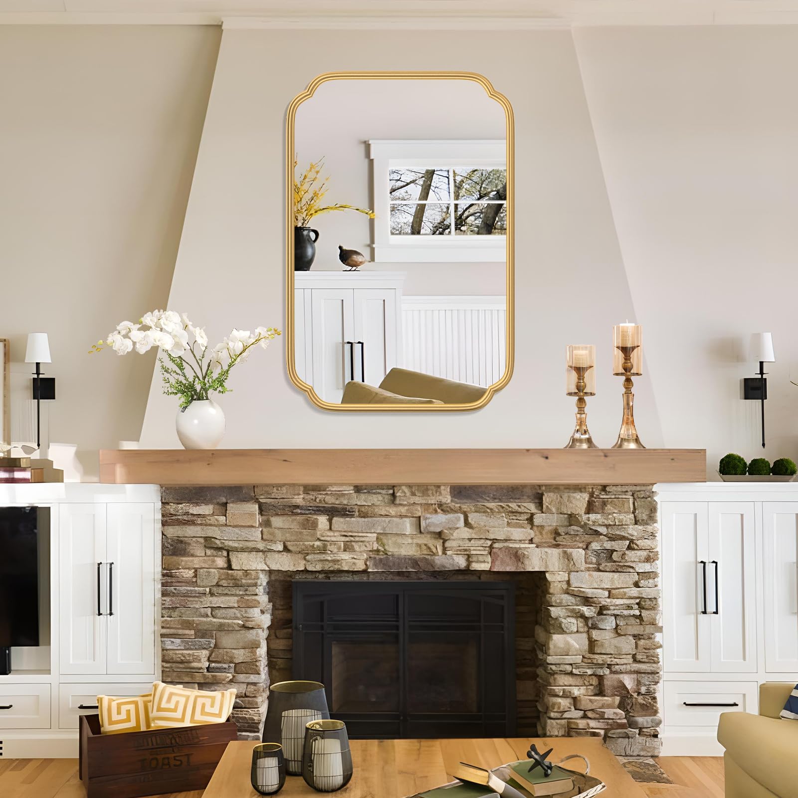 Ferytange gold rounded-rectangle mirror offers a modern focal point.