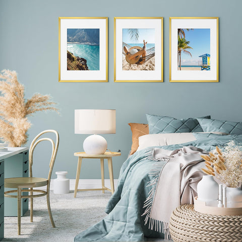 Fixwal family photo display in gold frames on a wall