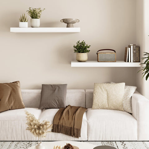 Fixwal white floating shelves used as living room decor and display.