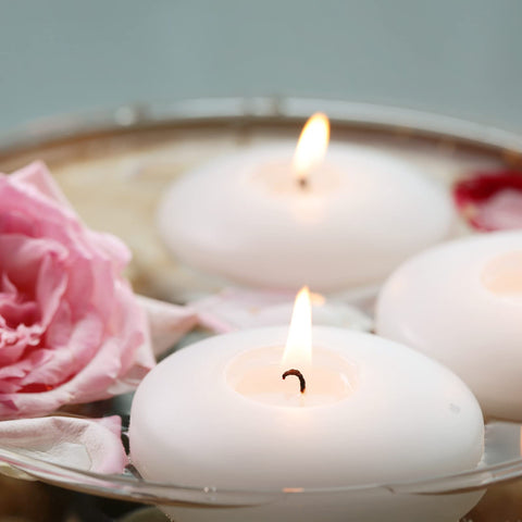 Flamecan wedding-reception floating candles add romantic glow to centerpieces.