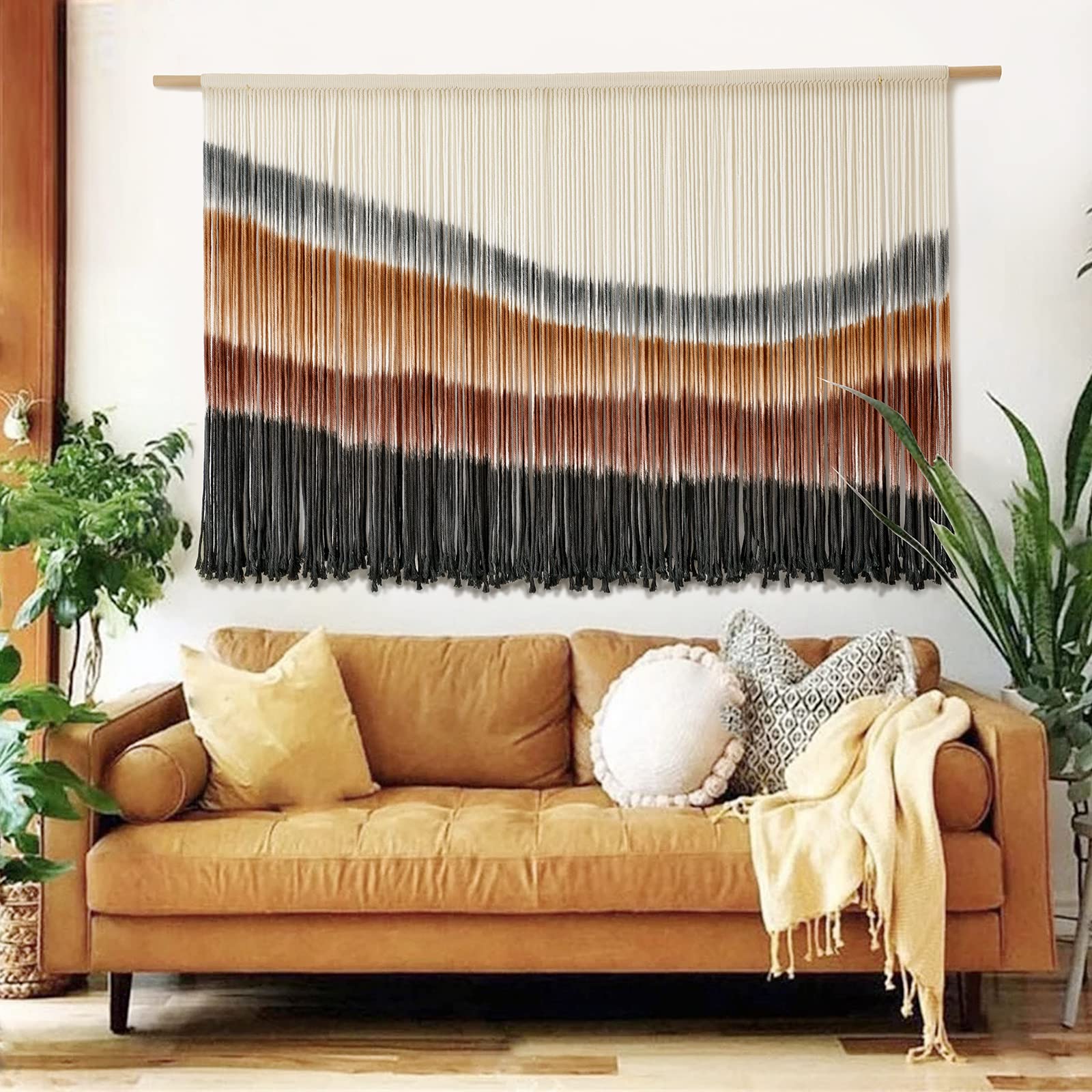 Flber macrame wall hanging with coffee tie-dye adds boho charm to living room decor.