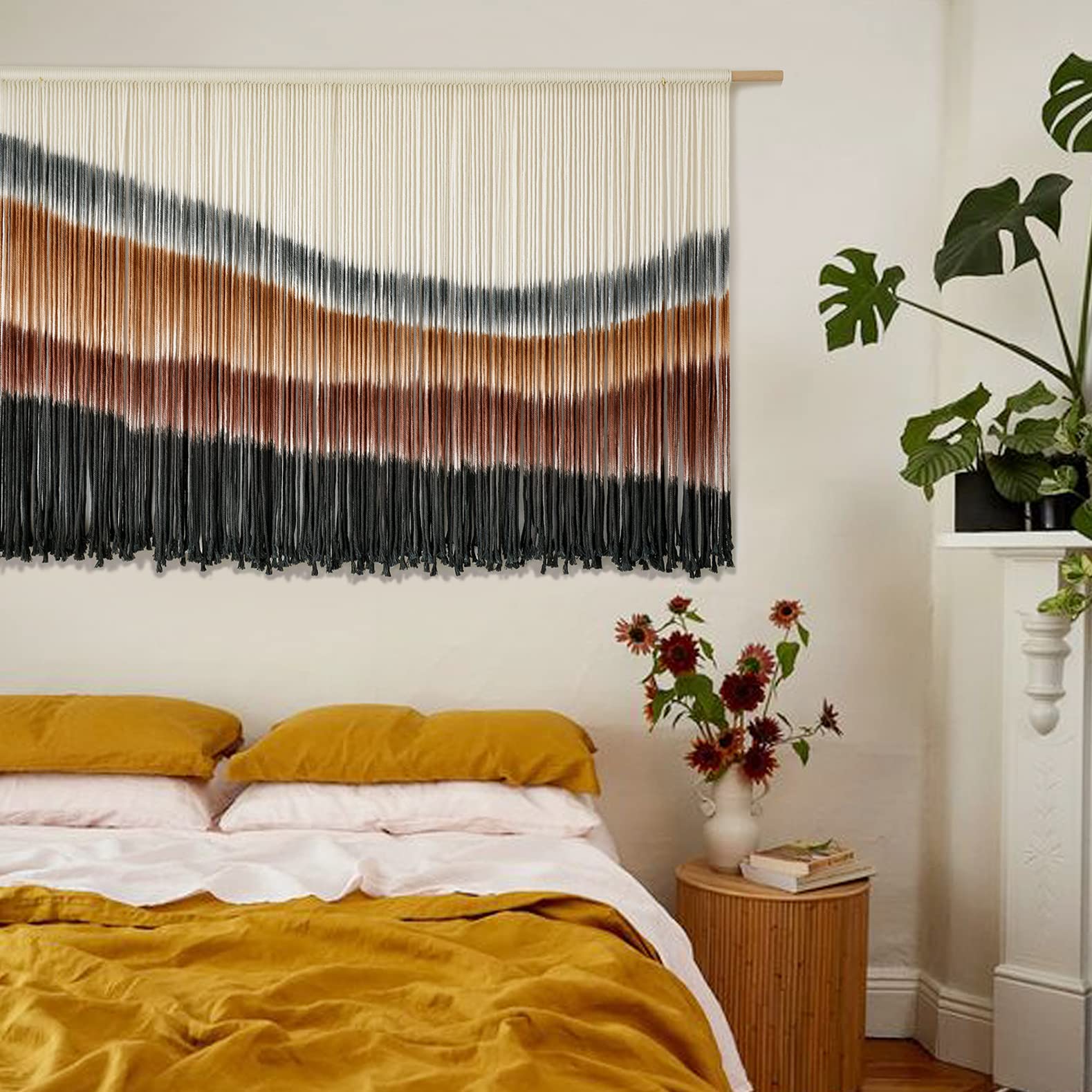 Flber macrame wall hanging in espresso tone blends with neutral palettes for cozy bedrooms.