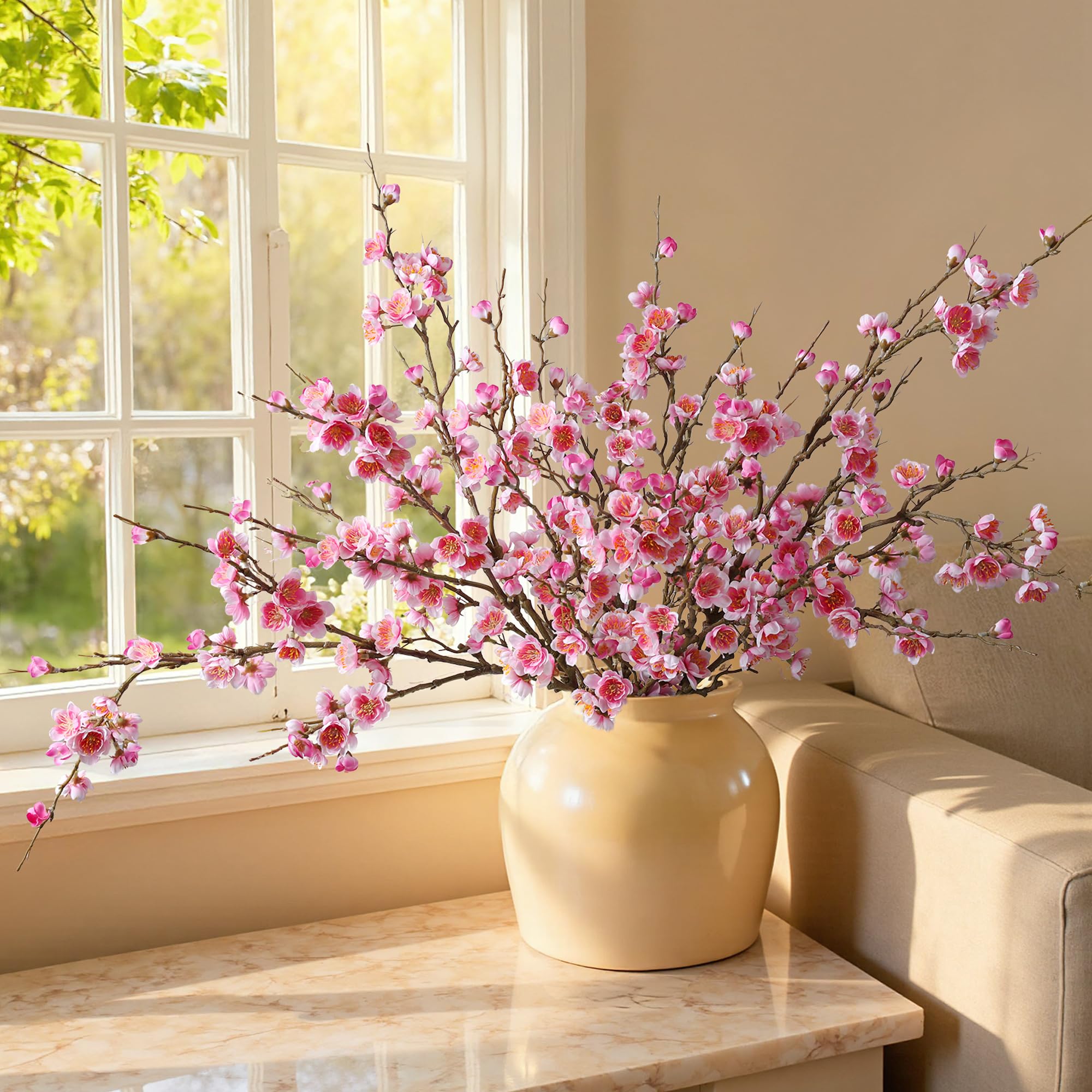 Florisso pink cherry blossom branch on office desk for a fresh look.