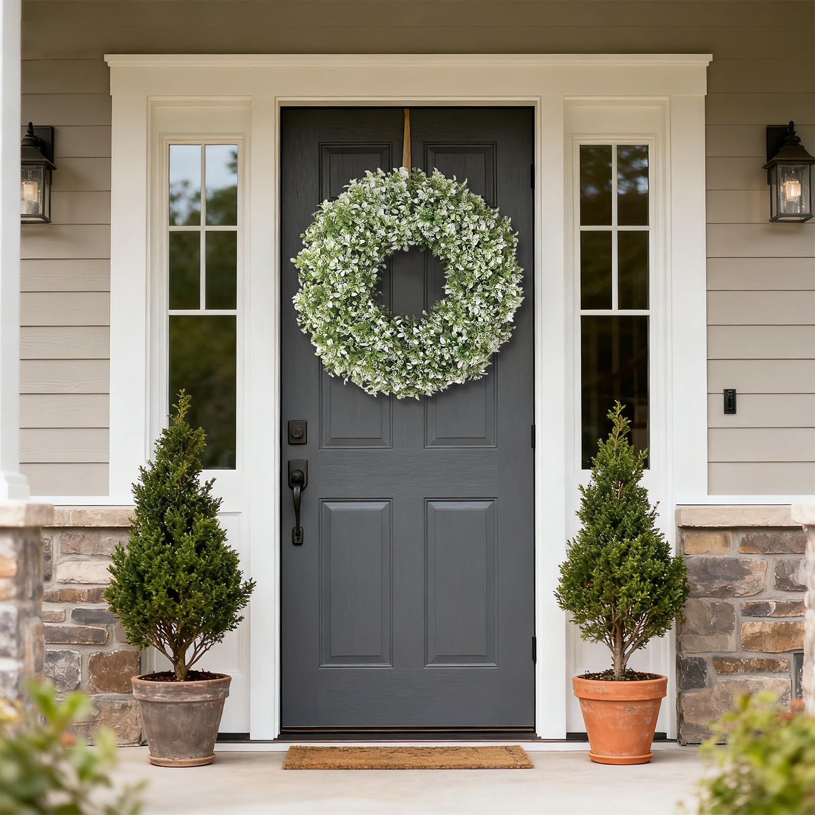 FOTEEWL artificial boxwood wreath on fireplace mantel adds natural texture.