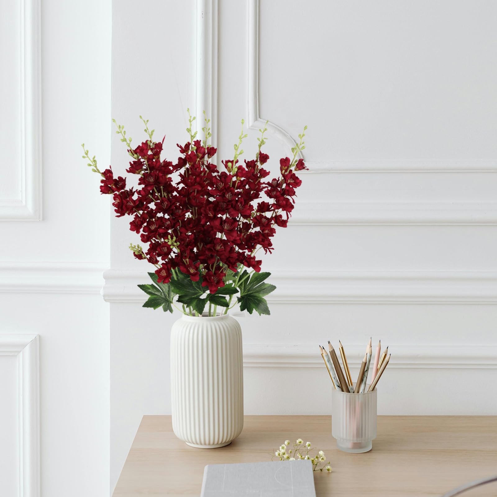 Fqueelvys tall faux delphinium stems stay vibrant year-round.