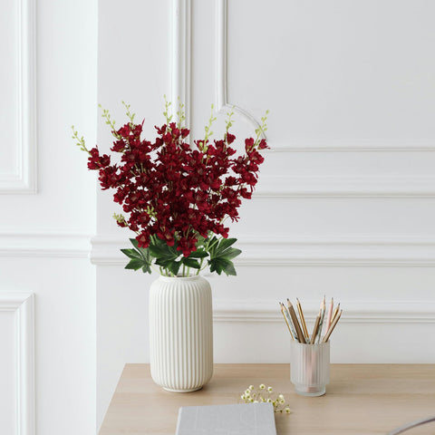 Fqueelvys tall faux delphinium stems stay vibrant year-round.
