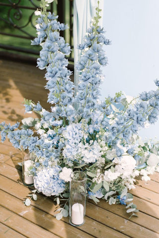 Fqueelvys delphinium stems showcased in a tall vase with graceful lines