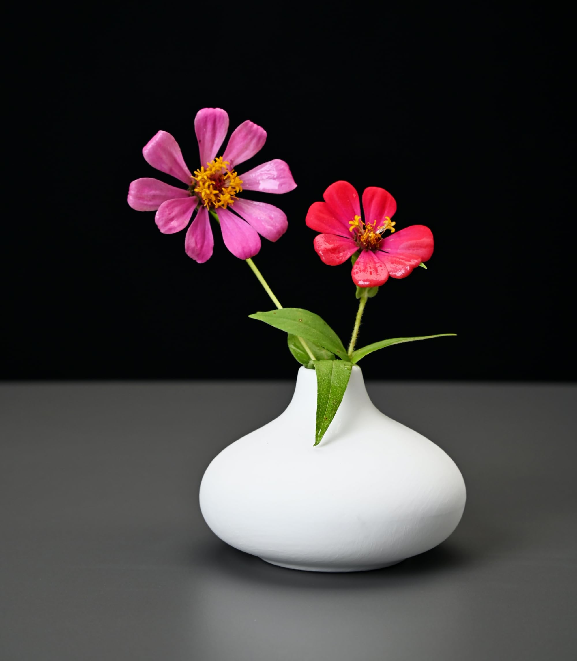 Fulloog bud vase round silhouette adds rustic charm to arrangements.